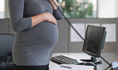 A pregnant woman working in office
